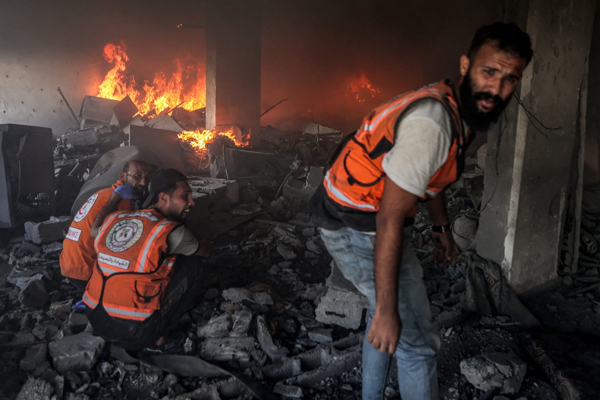 Palestinian civil defence try to extinguish a fire at a building hit by an Israeli strike in Gaza City in the central Gaza Strip, on July 2, 2025, amid the ongoing conflict between Israel and the Palestinian Hamas militant group.