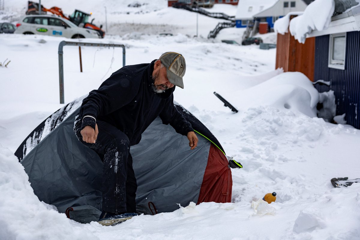 Rough sleeper Anders Maqe exits his tent surrounded by snow in Nuuk, Greenland, on March 6, 2025. Greenland, an autonomous Danish territory coveted by US President Trump and which votes on March 11, 2025 in legislative elections, is home to around 500 homeless people, or almost one percent of its population, according to a 2022 tally. The island's rapid modernisation and urbanisation over the past few decades is to blame. Since 1980 the population in Nuuk has doubled to 19,000 inhabitants, and the town aims to grow to 30,000 by 2030. Peppered with construction cranes, it now has a golf course, and as of last autumn, an international airport. And 150 homeless people. (Photo by Odd ANDERSEN / AFP)